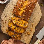 Chocolate chip pumpkin bread sliced and on a cutting board.