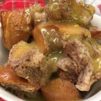 Cinnamon Spiced Bread Pudding with Butter Sauce is an easy and cheap treat for the Christmas holiday. I love the spice-filled taste with the creamy sauce.