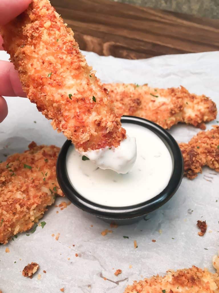 Baked Buttermilk Chicken Strips are a budget-friendly homemade dinner that is easy to make. The oven-baked chicken strips are breaded in buttermilk, parmesan cheese, herbs, and panko bread crumbs for a delicious and tasty dinner.