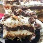 Chocolate layer dessert with a graham cracker crust, homemade whipped cream, chocolate pudding, and cream cheese is a delicious recipe. The easy recipe is the perfect dish for a party, the holidays, or for dessert at home.