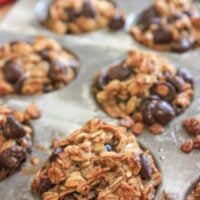 Mini oatmeal muffins with banana and chocolate chips in a metal muffin pan.