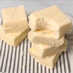 Pieces of white chocolate fudge stacked on top of each other.
