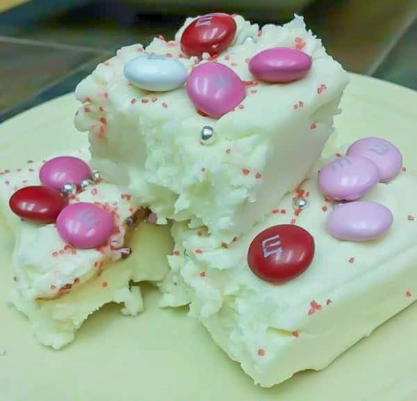 Square pieces of white chocolate fudge on a plate.