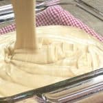 Picture of peanut butter fudge being poured into a glass dish