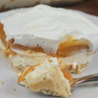 Butterscotch lush dessert on a plate with a fork.