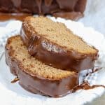 Picture of chocolate pound cake with frosting on a plate.