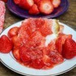 Picture of strawberry syrup on a piece of angel food cake.