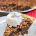 Picture of pecan pie with whipped cream on top.