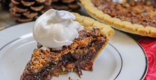 Picture of pecan pie with whipped cream.