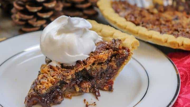 Picture of pecan pie with whipped cream.