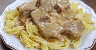 Picture of beef and noodles on a white plate