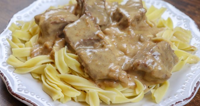 Picture of beef and noodles on a white plate
