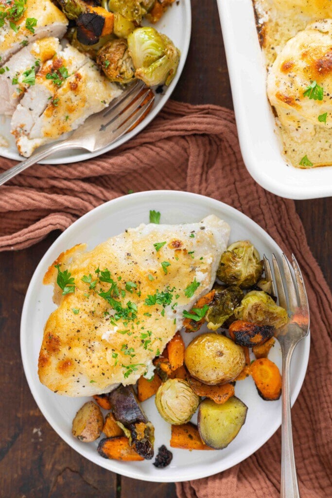 Chicken dinner on a white plate.