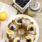 Lemon blueberry cake with lemonade, blueberries, and a lemon
