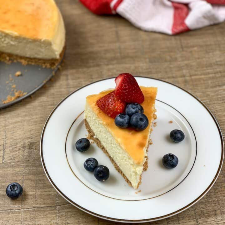 Cheesecake on a plate with strawberries and blueberries