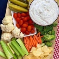 Sour cream dip and veggies on a cutting board