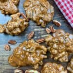 Praline pecans on a counter with pecans.