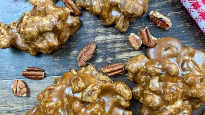Praline pecans on a counter with pecans.