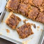 Pumpkin pecan pie bars cut up on a jelly roll pan