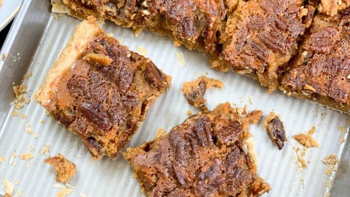 Pumpkin pecan pie bars cut up on a jelly roll pan