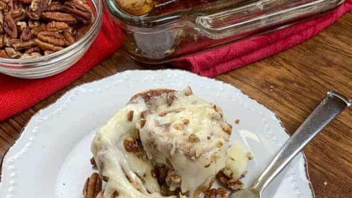 Cinnamon rolls in a dish and on a plate with pecans