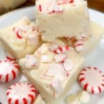 Peppermint fudge on a plate with peppermint candies