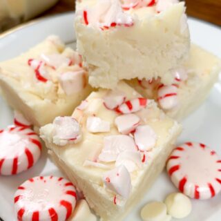 Peppermint fudge on a plate with peppermint candies