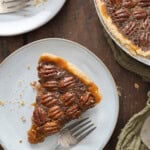 Slices of pecan pie on a white plate.
