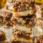 Pecan pie bars stacked on top of each other.