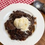 Slow cooker chocolate cake on a plate with vanilla ice cream