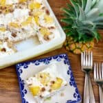 Pineapple lush on a blue and white plate with a casserole dish