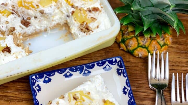 Pineapple lush on a blue and white plate with a casserole dish