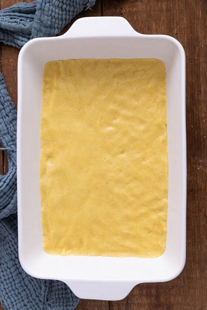 Picture of yellow cake pressed into a cake pan.