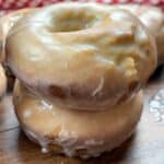 Two glazed donuts stacked on top of each other.