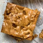 Sliced brown butter blondie on parchment paper