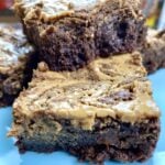Peanut butter brownies stacked on top of each other.