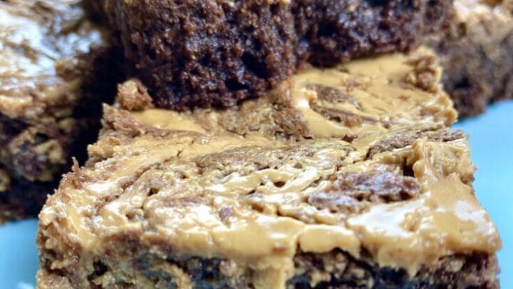 Peanut butter brownies stacked on top of each other.