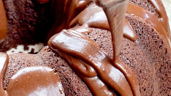 Pouring chocolate icing on a brownie cake.