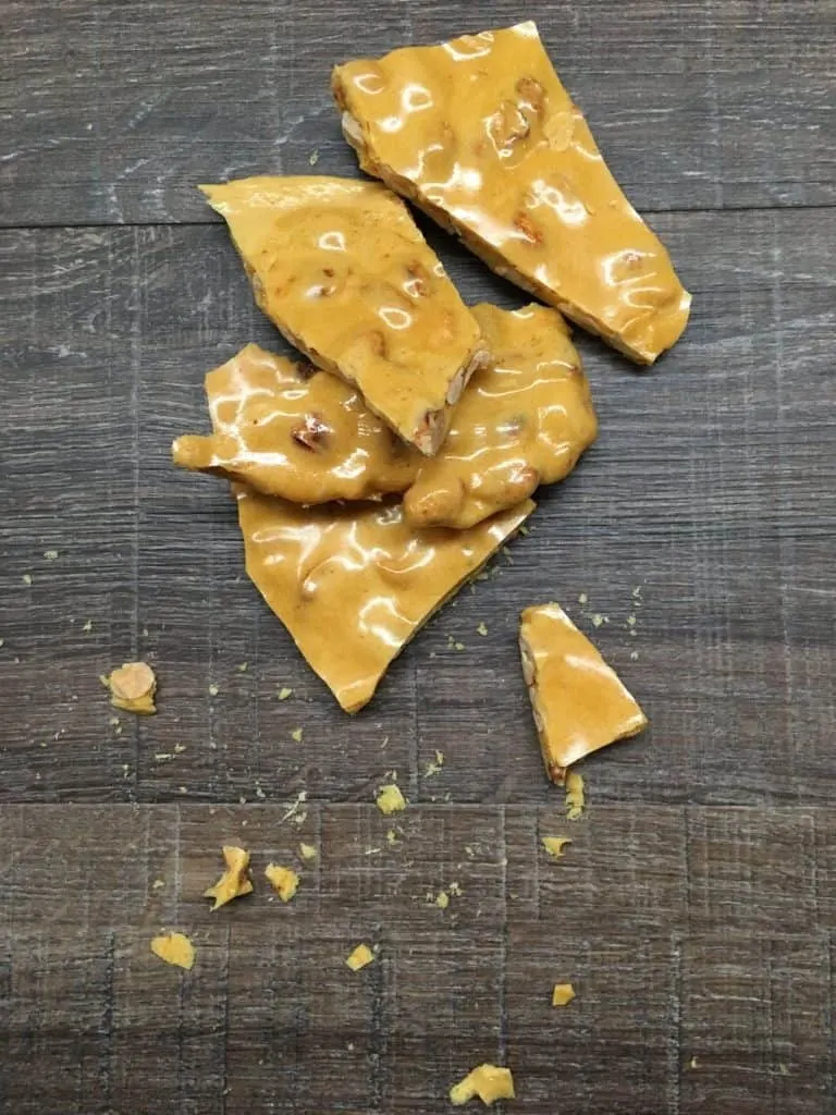 Easy peanut brittle in pieces on the counter.