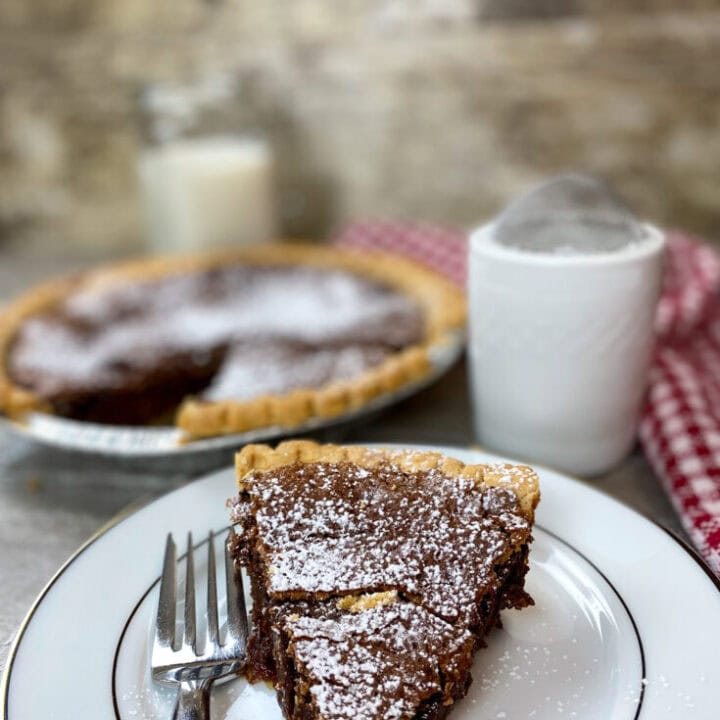 Chocolate chess pie on a plate.