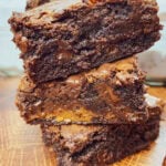 Three caramel brownies stacked on top of each other.