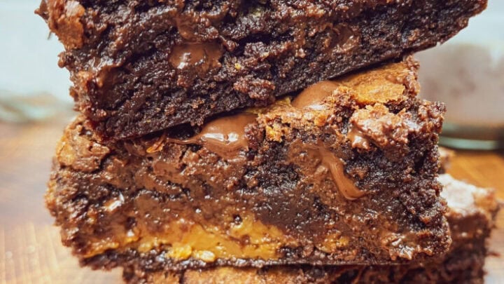 Three caramel brownies stacked on top of each other.