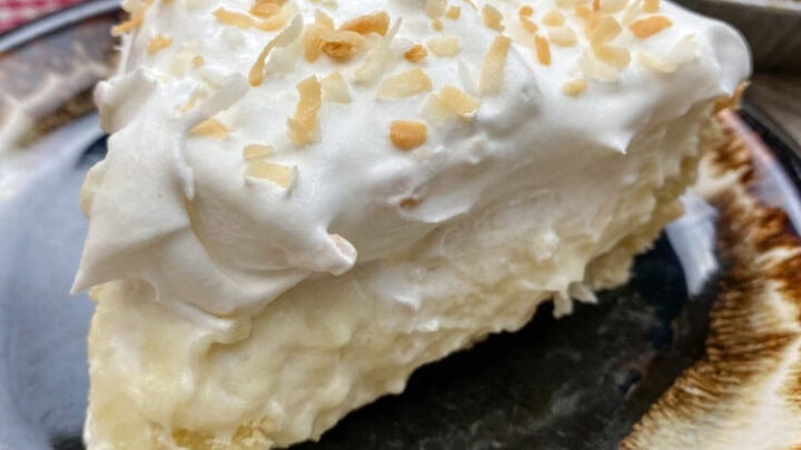 A slice of coconut cream pie on a plate.