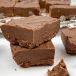 Easy two ingredient fudge sliced and stacked on top of each other.