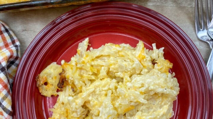 Hashbrown casserole on a red plate.
