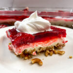 Raspberry pretzel Jello salad on a white plate