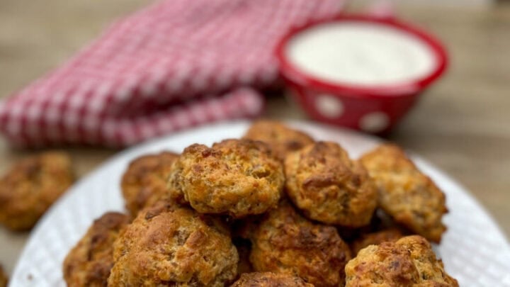 Sausage balls with cream cheese on a white plate.