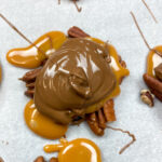 Turtle candy on a cookie sheet with parchment paper.