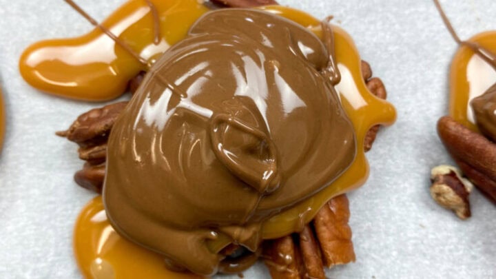 Turtle candy on a cookie sheet with parchment paper.