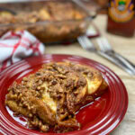 Overnight French toast casserole on a red plate.
